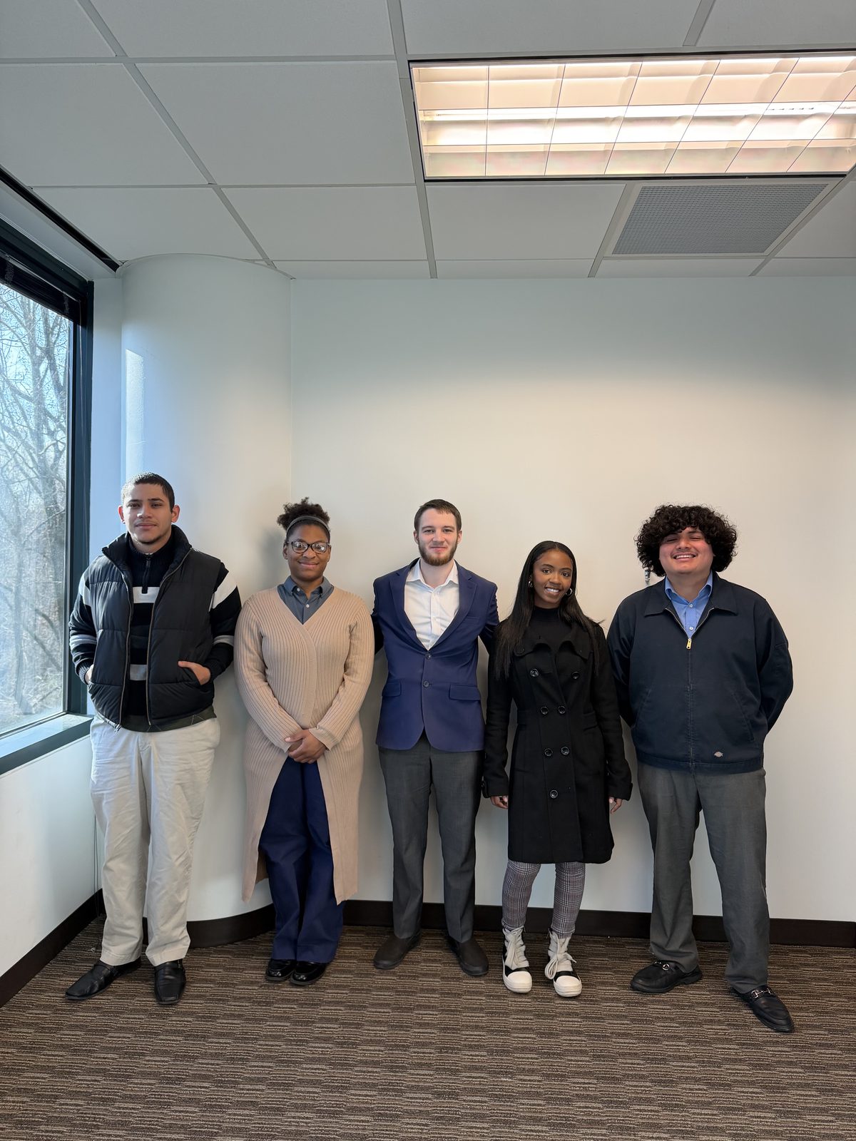 Summit Ridge team posed together in a professional office setting