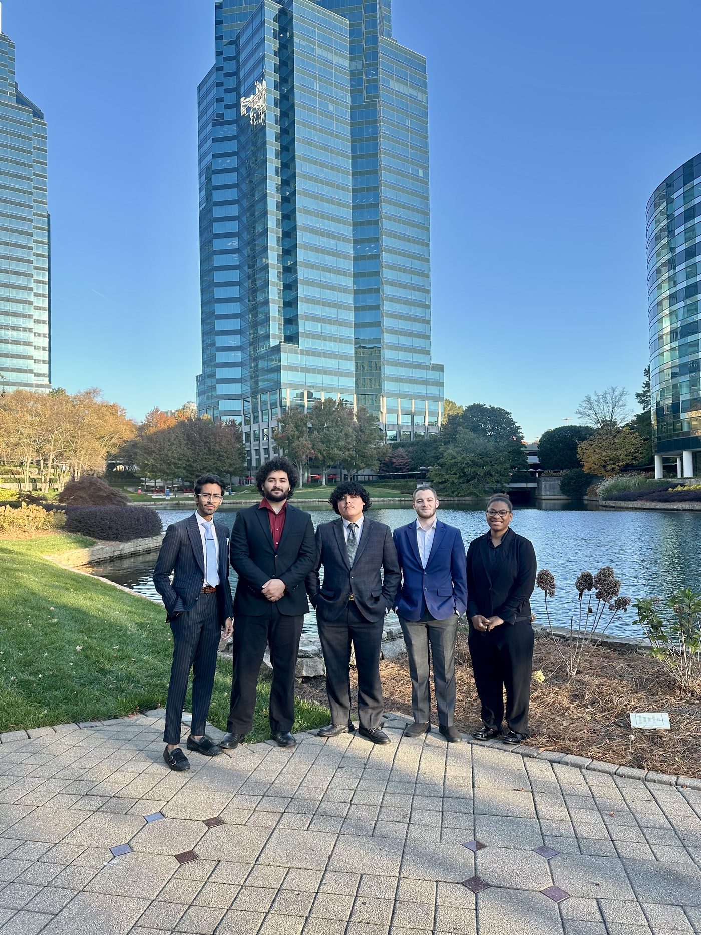 Summit Ridge team members standing outdoors in front of a corporate skyline